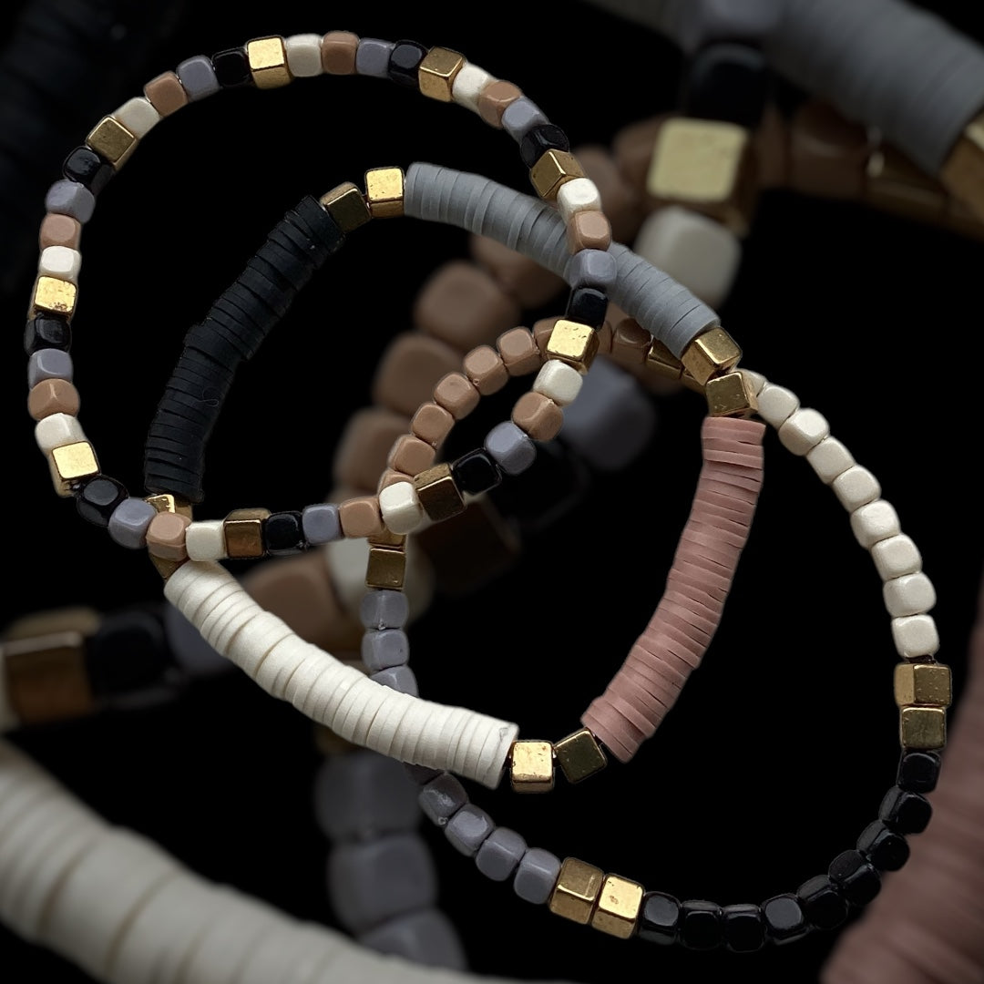 Stone Blend bracelet stack – neutral beads and gold cube spacers
Handmade stretch bracelet trio in grey, taupe, ivory, and blush
Neutral beaded bracelet set with gold accents – Stone Blend by Pxl Nate
Textured 3-piece bracelet stack with matte cube beads and clay discs
Earthy toned bracelet trio with polymer and glass beads – UK handmade