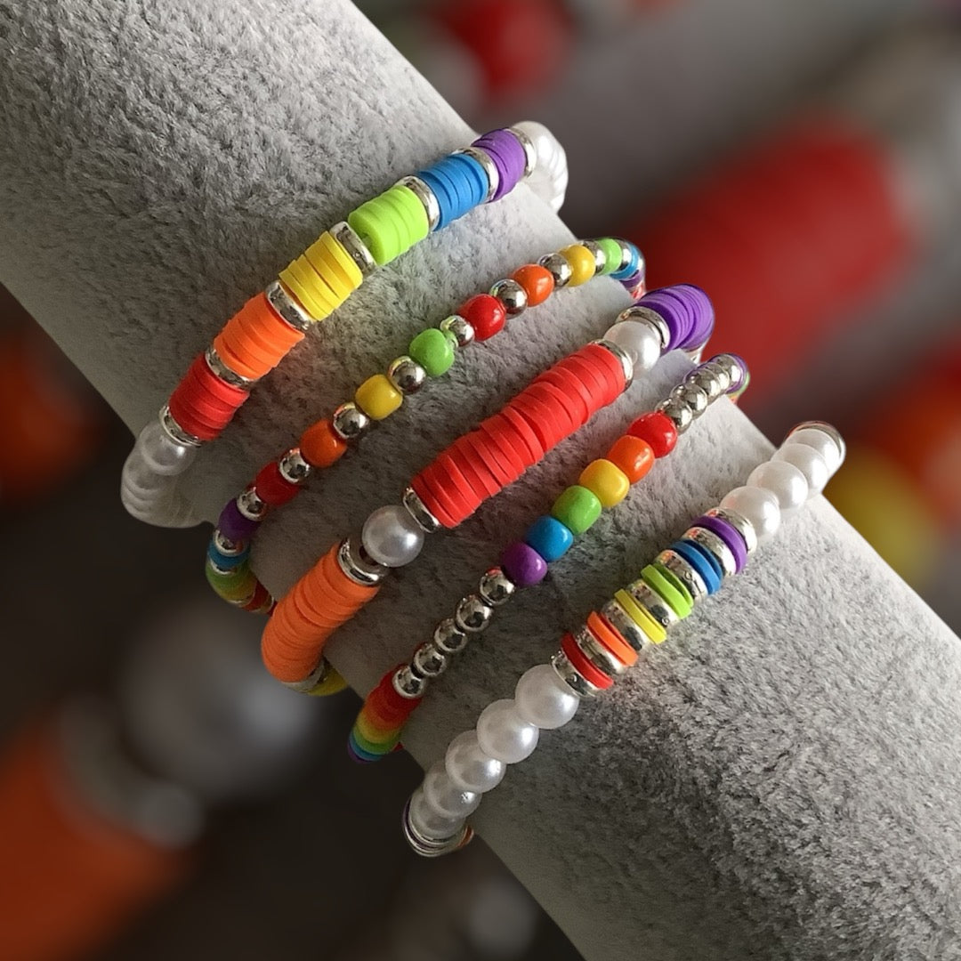Rainbow Rush bracelet stack – 5-piece set with rainbow colours and silver accents
Handmade bracelet set with pearl-look beads, clay discs, and seed beads
Bright multicolour bracelet stack – Rainbow Rush by Pxl Nate
Bold 5-piece beaded bracelet set with silver spacers and rainbow tones
Joyful stretch bracelet set with mixed textures – UK handmade