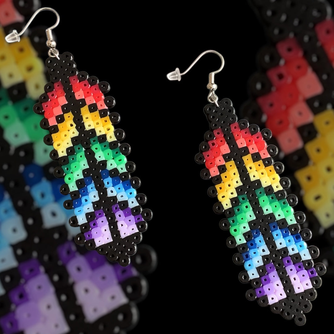 Handmade fuse bead earrings featuring rainbow pixel-style feather design with nickel-free hook findings on kraft card backing