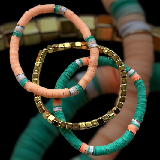 Coral Palm bracelet stack – emerald green, peach, and gold cube beads

Handmade bracelet trio with polymer discs and chunky gold spacers

Bold stretch bracelet set in coral and green – Coral Palm by Pxl Nate

Statement jewellery with gold cube beads and bright polymer discs

Vibrant 3-piece handmade bracelet stack – perfect for summer styling