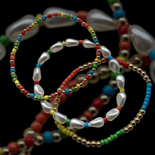 “Delicate rainbow beaded bracelet stack with faux pearls on white background”

“Set of 3 thin polymer clay and pearl bracelets in bright colours”

“Lightweight handmade bracelet stack with multicolour beads and soft pearls”